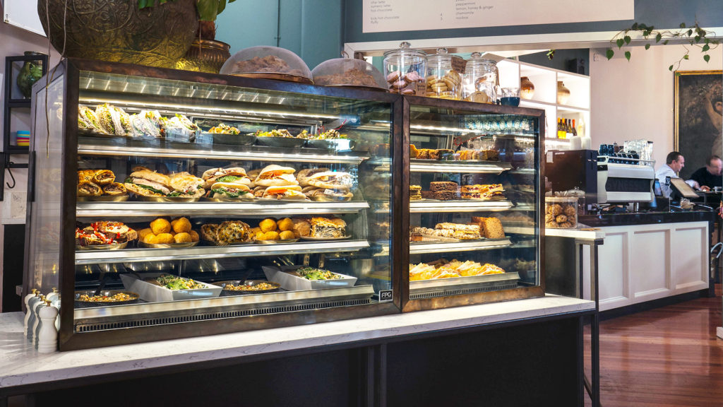 Image showing FPG Inline Series food display cabinets with custom copper clad frames installed at Ajuna Eatery, Napier, New Zealand.
