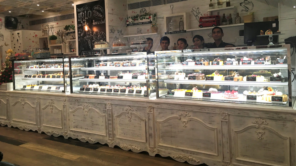 Image showing a lineup of custom Inline 3000 food display cabinets installed at the High Street Bakery, India.