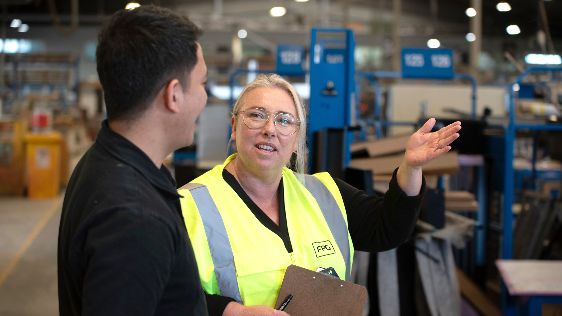 Image showing FPG HR manager with staff member on manufacturing floor.