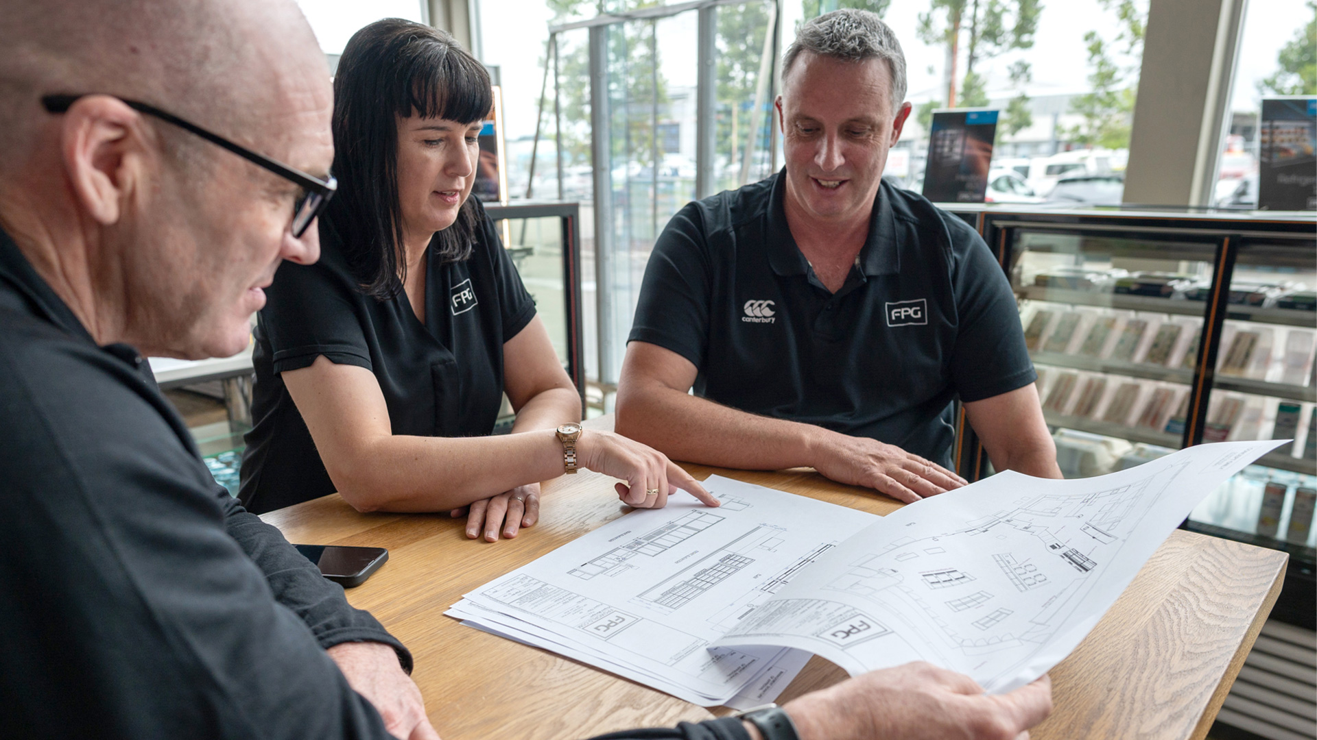 Image showing FPG Sales team reviewing a project plans together.