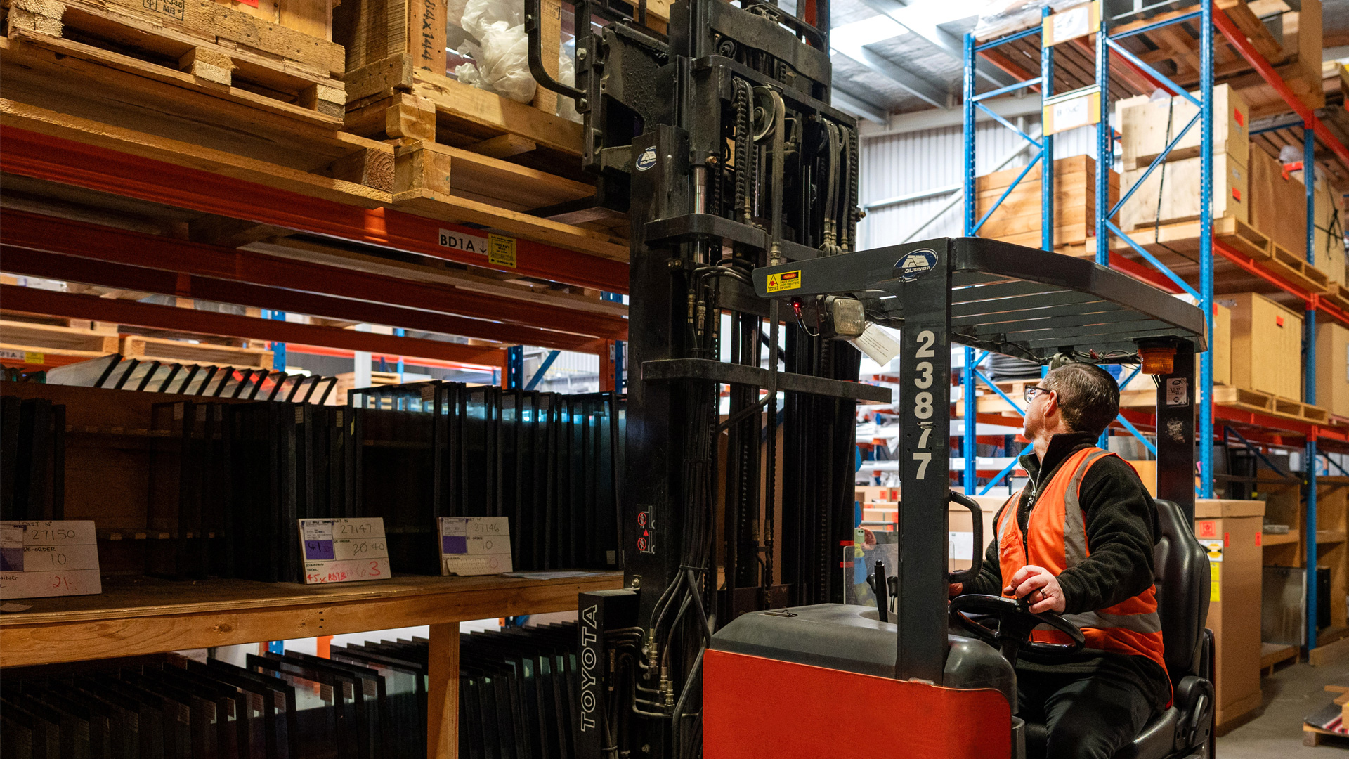 Image showing staff operating machinery in the FPG B-Store where the cabinet components and spare parts are held.