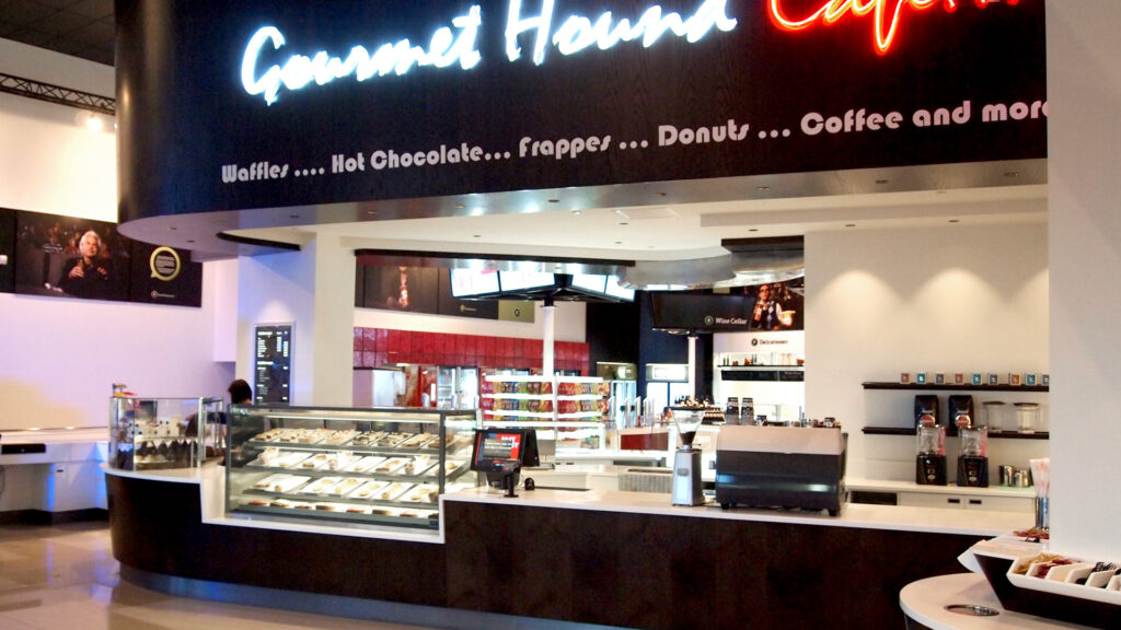 Image showing Gourmet Hound Cafe, Hoyts Cinema, Hamilton, New Zealand. Custom fitout including counter joinery, refrigerated food display cabinet, condiments station, and signage.