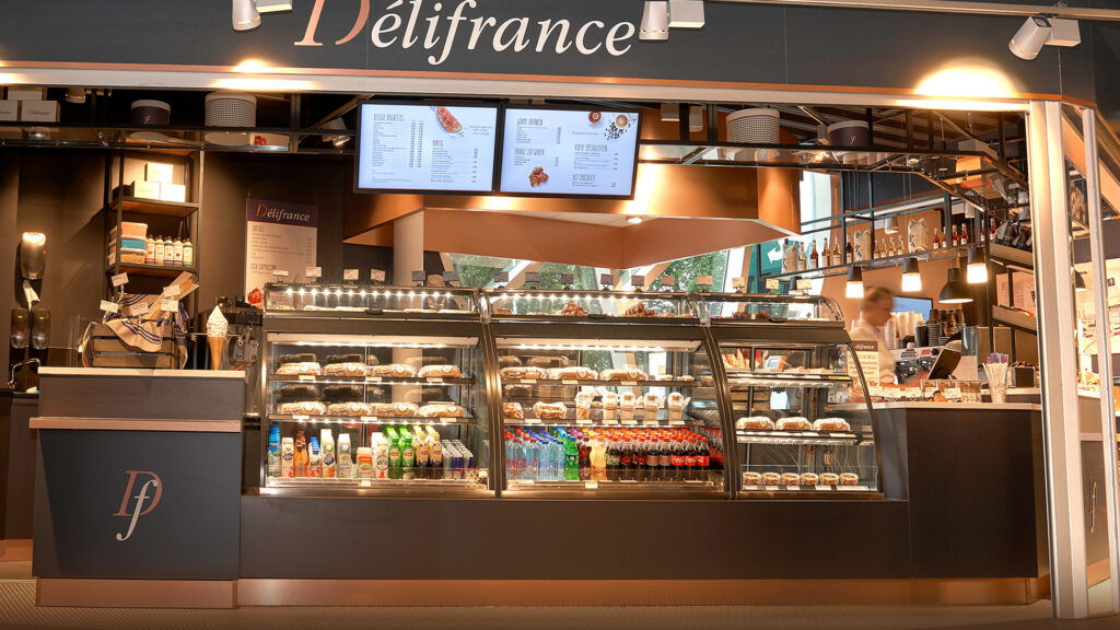 Custom Inline 5000 Curved Open Front refrigerated food display cabinets fitted with 2 shelves and top ambient display at Délifrance, The Netherlands.