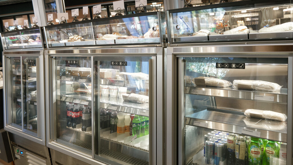 The rear view of the Inline 5000 refrigerated food display cabinets fitted with custom top displays for ambient bakery products at Délifrance, The Netherlands.