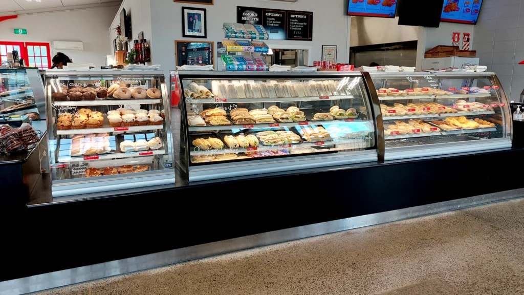 Image showing Fire Station Bakery Café, Hastings, New Zealand. A lineup of curved heated and refrigerated FPG Inline 5000 Series food display cabinets complete with joinery.