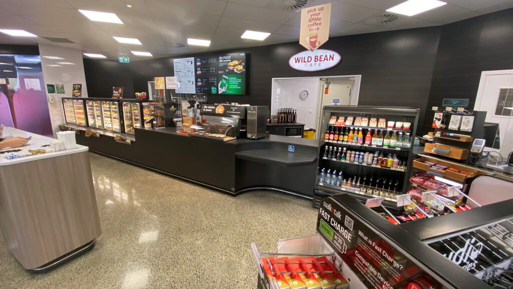 A lineup of FPG Inline food display cabinets and FPG Visair Upright refrigerated drinks display at BP Papamoa Wild Bean Cafe, Tauranga, New Zealand.