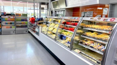 FPG Custom Cabinet: Impulse Slim 13H 09W Refrigerated and Inline 5000 Series Curved Open Front Image showing the FPG Impulse Slim 13H 09W refrigerated cabinets used for merchandising icy cold drinks, and FPG Inline 5000 Series Curved Open Front food display cabinets. 7 Eleven, Australia.